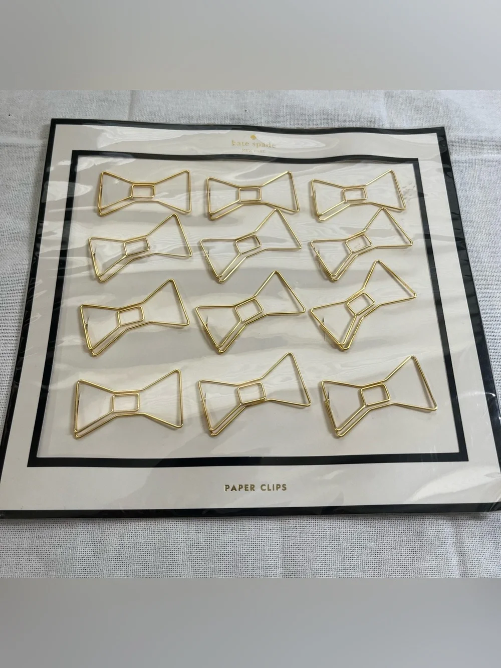 kate spade gold bow paper clips - 12 per package.